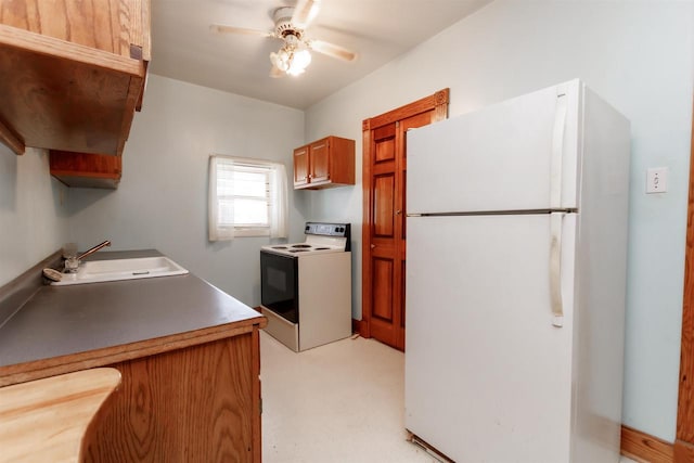 302 W Division St, Fond Du Lac, WI 54935 - kitchen with freestanding refrigerator, electric stove, a sink, a ceiling fan, and brown cabinetry