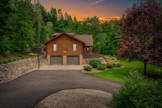 N17795 Trim Rd, Galesville, WI 54630 - cabin with log exterior, driveway, an attached garage, stone siding, and stairs