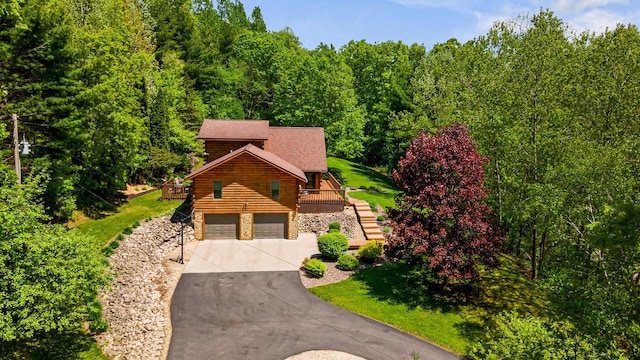 N17795 Trim Rd, Galesville, WI 54630 - view of front of property featuring driveway, a garage, a deck, and stairway