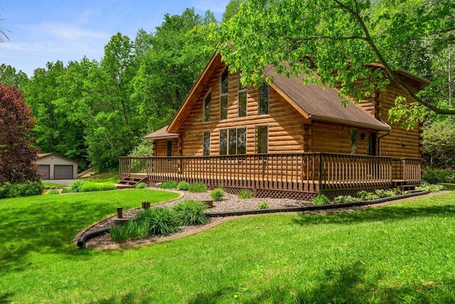 N17795 Trim Rd, Galesville, WI 54630 - back of house with log siding, a garage, a wooden deck, a lawn, and an outdoor structure
