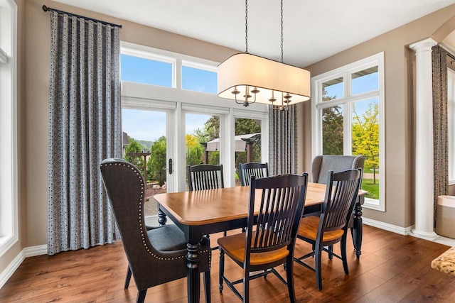 W4825 Wild Wings Dr, Sherwood, WI 54169 - dining space with decorative columns, baseboards, wood finished floors, and a chandelier