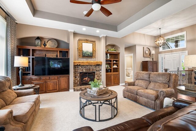 W4825 Wild Wings Dr, Sherwood, WI 54169 - living area featuring a ceiling fan, built in features, carpet, a glass covered fireplace, and a chandelier