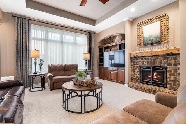 W4825 Wild Wings Dr, Sherwood, WI 54169 - living room featuring carpet flooring, a ceiling fan, a brick fireplace, recessed lighting, and a tray ceiling