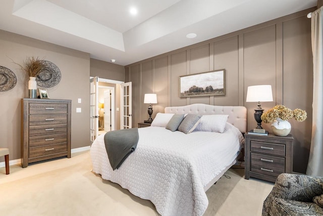 W4825 Wild Wings Dr, Sherwood, WI 54169 - bedroom with light carpet, french doors, a decorative wall, baseboards, and a raised ceiling