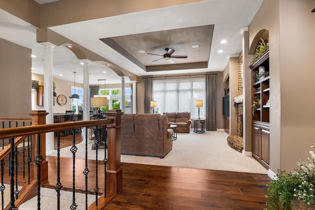 W4825 Wild Wings Dr, Sherwood, WI 54169 - living area with ceiling fan, hardwood / wood-style flooring, ornate columns, baseboards, and a tray ceiling