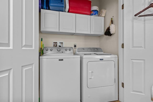 1242 Liberty St, Oshkosh, WI 54901 - washroom with washer and clothes dryer and cabinet space