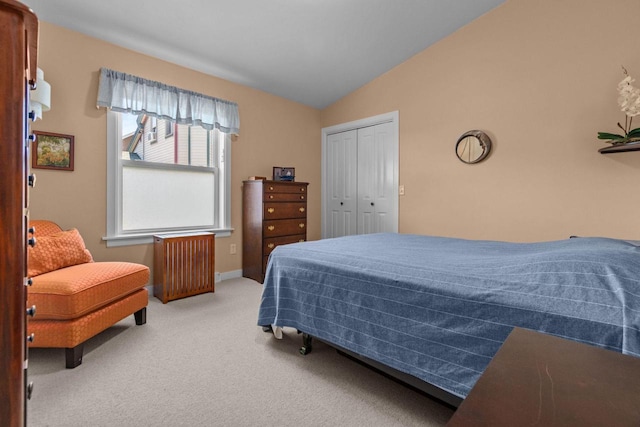 1242 Liberty St, Oshkosh, WI 54901 - bedroom featuring radiator, vaulted ceiling, carpet floors, a closet, and baseboards