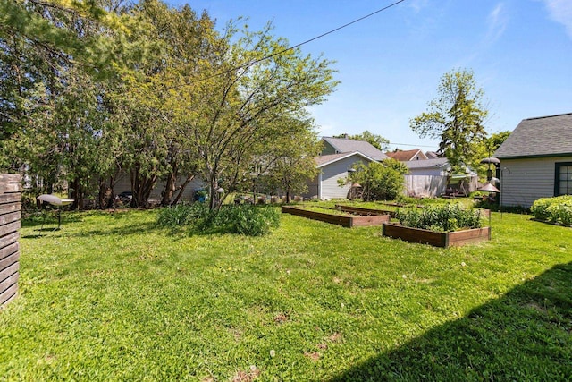 1242 Liberty St, Oshkosh, WI 54901 - view of grassy yard with a vegetable garden