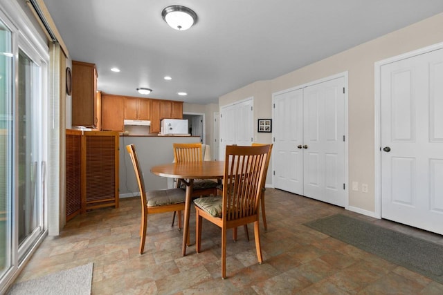 1242 Liberty St, Oshkosh, WI 54901 - dining space featuring stone finish floors, recessed lighting, and baseboards