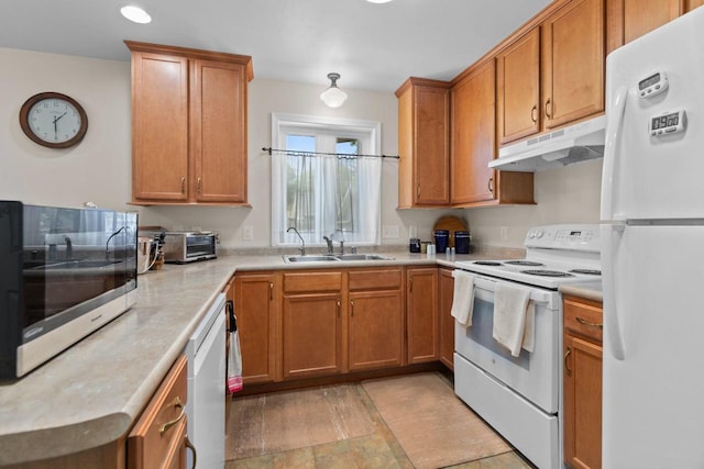 1242 Liberty St, Oshkosh, WI 54901 - kitchen with white appliances, under cabinet range hood, light countertops, a sink, and brown cabinetry