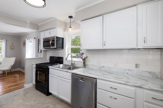 2801 Harvey St, La Crosse, WI 54603 - kitchen featuring stainless steel appliances, a sink, tasteful backsplash, crown molding, and white cabinetry