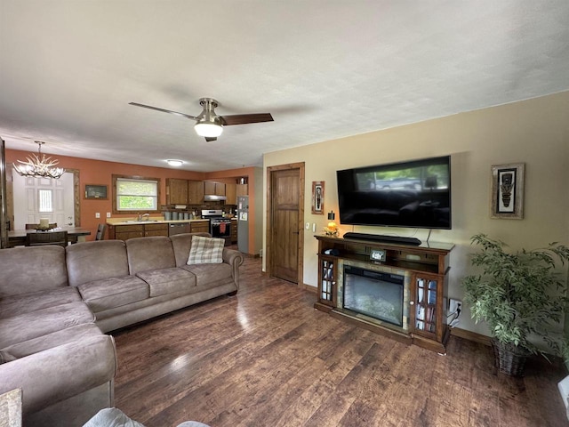 N3140 Forest Prairie Park Rd, Monroe, WI 53566 - living room featuring wood finished floors, a chandelier, baseboards, and a ceiling fan