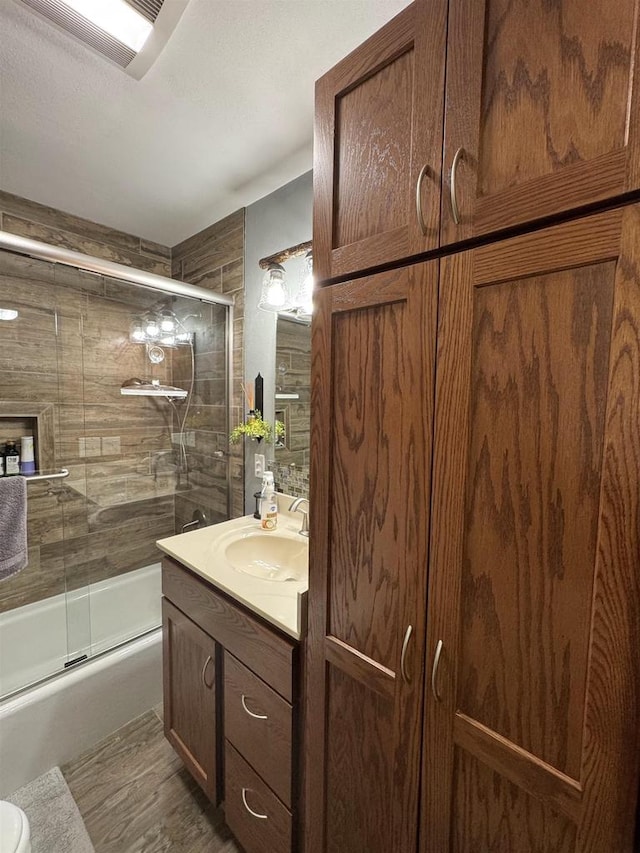 N3140 Forest Prairie Park Rd, Monroe, WI 53566 - bathroom featuring vanity, enclosed tub / shower combo, and wood finished floors