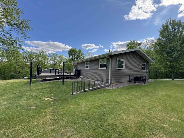 N3140 Forest Prairie Park Rd, Monroe, WI 53566 - view of property exterior featuring a deck, a lawn, and central air condition unit