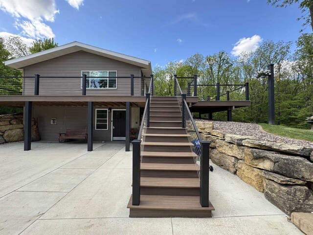 N3140 Forest Prairie Park Rd, Monroe, WI 53566 - back of property with stairs, a wooden deck, and a patio