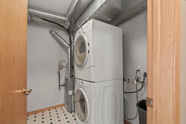 10 Kings Mill Cir Unit 113, Madison, WI 53718 - laundry room featuring stacked washer / dryer, light floors, and baseboards