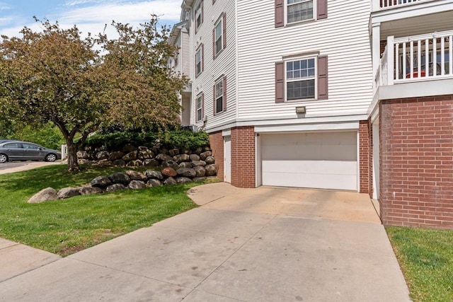 10 Kings Mill Cir Unit 113, Madison, WI 53718 - view of front of property featuring a garage, concrete driveway, brick siding, and a front yard