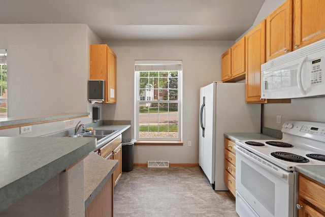 10 Kings Mill Cir Unit 113, Madison, WI 53718 - kitchen featuring white appliances, a sink, baseboards, and light colored carpet