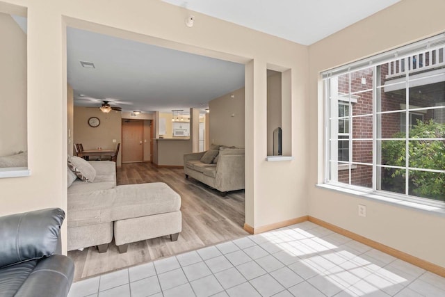 10 Kings Mill Cir Unit 113, Madison, WI 53718 - living area featuring healthy amount of natural light, a ceiling fan, baseboards, and light tile patterned floors