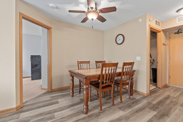 10 Kings Mill Cir Unit 113, Madison, WI 53718 - dining room featuring light wood-style floors, a ceiling fan, and baseboards
