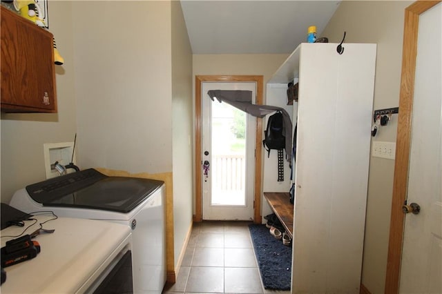 1808 Curtiss St, Eau Claire, WI 54703 - washroom featuring cabinet space, washing machine and dryer, and light tile patterned floors