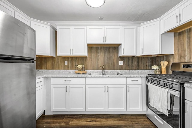 6112 W Port Ave, Milwaukee, WI 53223 - kitchen with stainless steel appliances, a sink, white cabinets, and dark wood-style floors