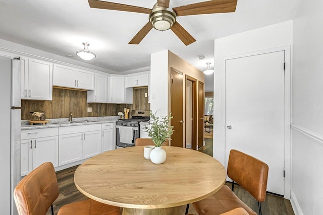6112 W Port Ave, Milwaukee, WI 53223 - dining space featuring ceiling fan, dark wood-type flooring, and baseboards
