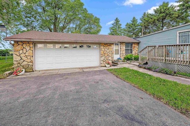 N10678 US Highway 151, Malone, WI 53049 - view of front of home with stone siding, roof with shingles, and a wooden deck