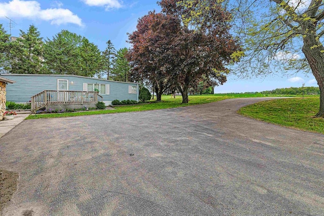 N10678 US Highway 151, Malone, WI 53049 - view of front of house with a wooden deck and a front lawn