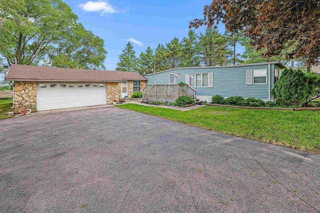 N10678 US Highway 151, Malone, WI 53049 - view of front of property with asphalt driveway, stone siding, an attached garage, and a front yard