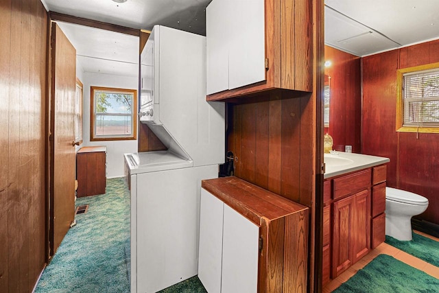 N10678 US Highway 151, Malone, WI 53049 - laundry room with estacked washer and dryer, carpet floors, and wooden walls