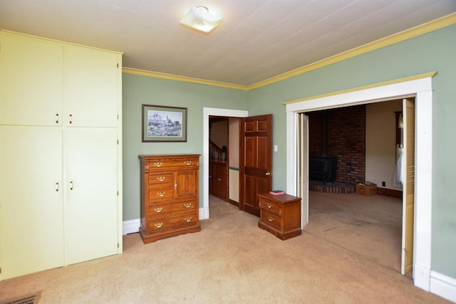 735 Oakwood St, Wild Rose, WI 54984 - bedroom with light colored carpet, crown molding, a wood stove, and a closet