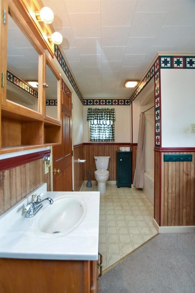 735 Oakwood St, Wild Rose, WI 54984 - full bathroom with vanity, wainscoting, toilet, shower / bathtub combination with curtain, and wooden walls