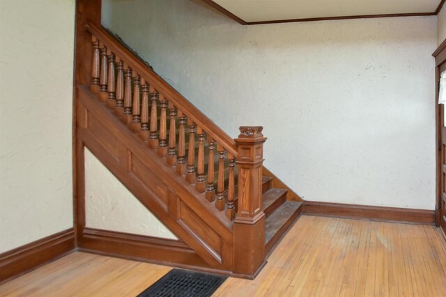 735 Oakwood St, Wild Rose, WI 54984 - stairway with wood-type flooring, baseboards, and crown molding