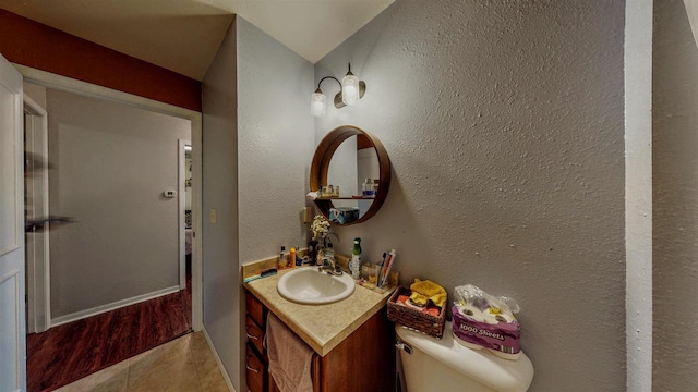 619 Reena Ave Unit 8, Fort Atkinson, WI 53538 - bathroom with vanity, toilet, tile patterned floors, baseboards, and a textured wall