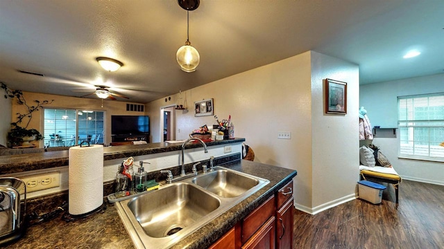619 Reena Ave Unit 8, Fort Atkinson, WI 53538 - kitchen with a sink, dark countertops, ceiling fan, dark wood finished floors, and baseboards