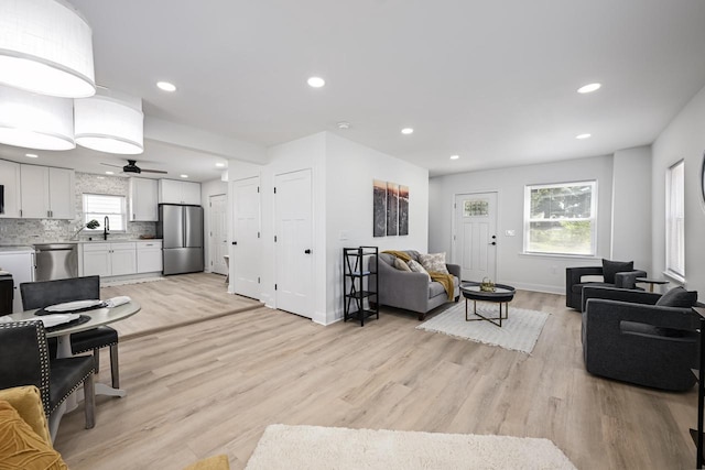 1922 E Iron St, Milwaukee, WI 53207 - living room with light wood-type flooring, baseboards, ceiling fan, and recessed lighting