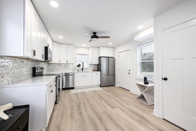 1922 E Iron St, Milwaukee, WI 53207 - kitchen featuring appliances with stainless steel finishes, ceiling fan, a sink, light countertops, and white cabinets