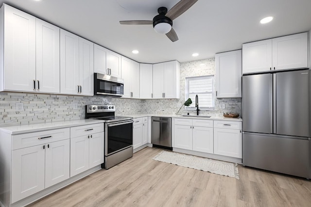 1922 E Iron St, Milwaukee, WI 53207 - kitchen featuring appliances with stainless steel finishes, a sink, a ceiling fan, light countertops, and tasteful backsplash