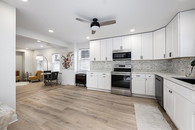 1922 E Iron St, Milwaukee, WI 53207 - kitchen featuring appliances with stainless steel finishes, tasteful backsplash, light countertops, ceiling fan, and recessed lighting