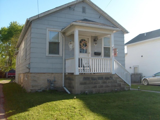 1330 Ceape Ave, Oshkosh, WI 54901 - view of front facade featuring covered porch and a front lawn