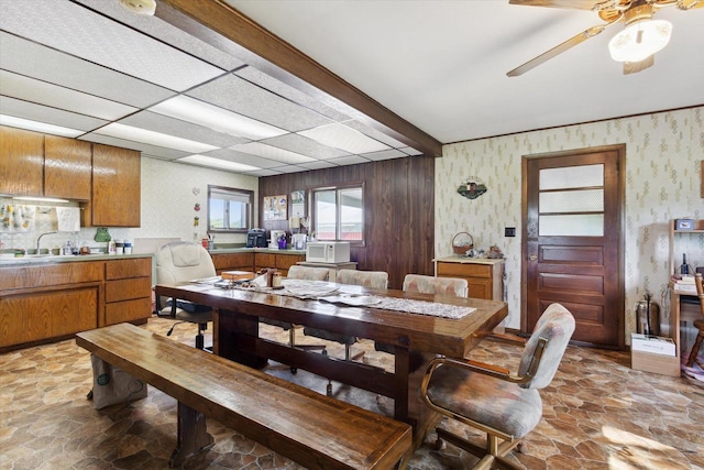 N1815 County Road T, Brodhead, WI 53520 - dining area with stone floors, wallpapered walls, and a ceiling fan