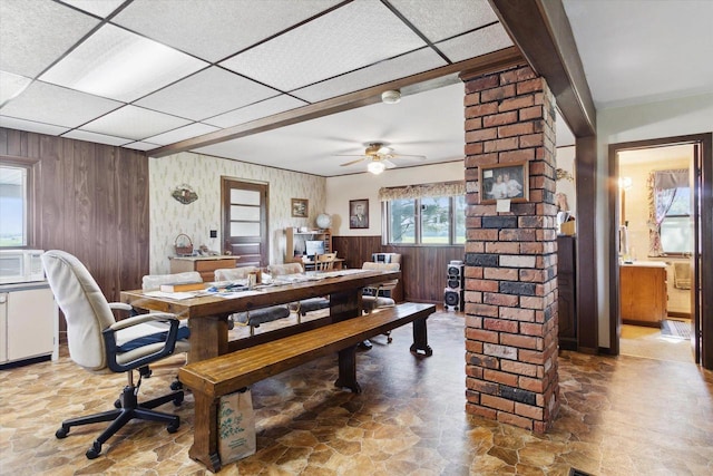 N1815 County Road T, Brodhead, WI 53520 - dining area featuring stone finish flooring, a drop ceiling, wood walls, ceiling fan, and a desk