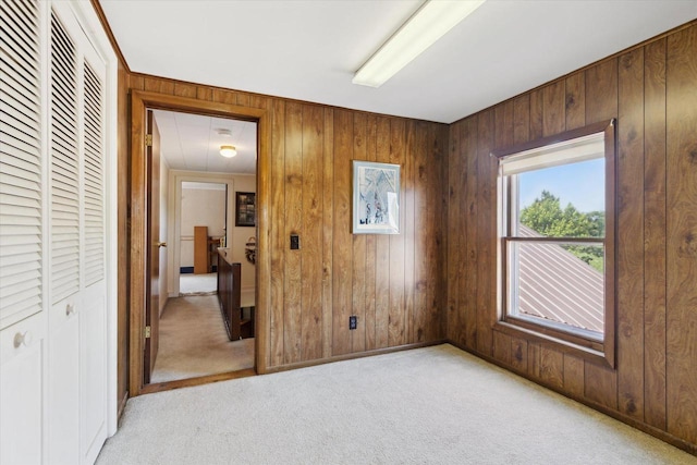 N1815 County Road T, Brodhead, WI 53520 - unfurnished bedroom featuring light carpet, wooden walls, attic access, and a closet
