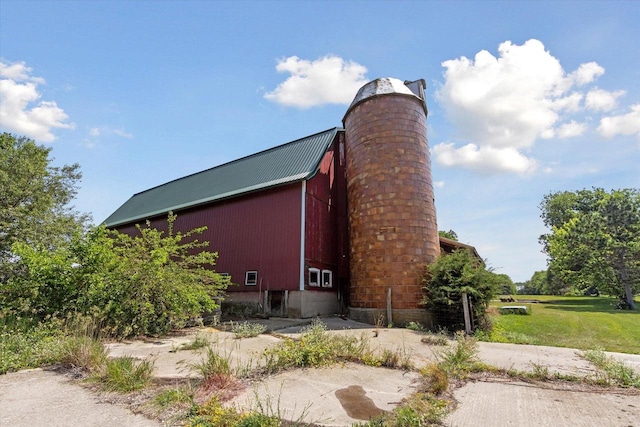 N1815 County Road T, Brodhead, WI 53520 - view of side of home with a barn, an outdoor structure, a metal roof, and a chimney