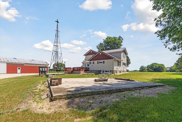 N1815 County Road T, Brodhead, WI 53520 - view of grassy yard with a deck, a patio area, and a pole building