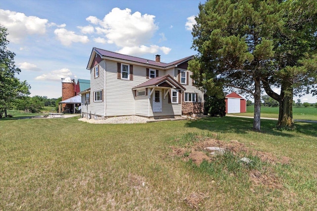 N1815 County Road T, Brodhead, WI 53520 - view of front of home with a front yard, a chimney, and an outbuilding