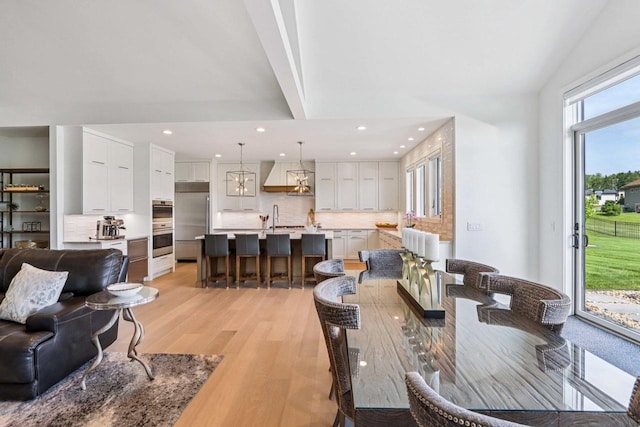 7678 Badger Run Ct, Verona, WI 53593 - dining area with light wood finished floors, recessed lighting, and high vaulted ceiling