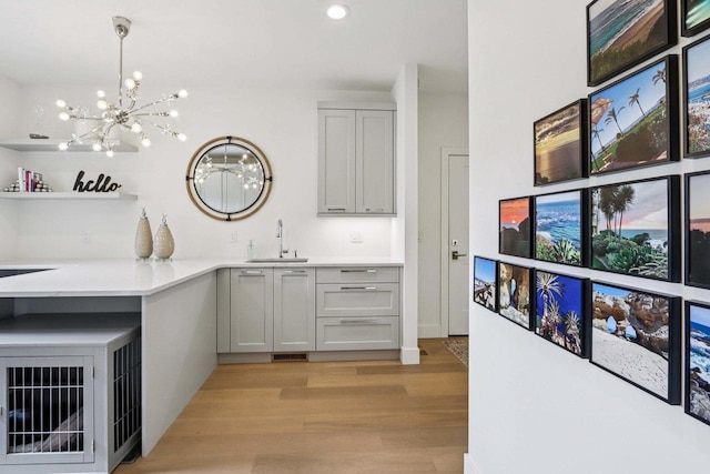 7678 Badger Run Ct, Verona, WI 53593 - bar with a sink, light wood-style flooring, a chandelier, recessed lighting, and hanging light fixtures