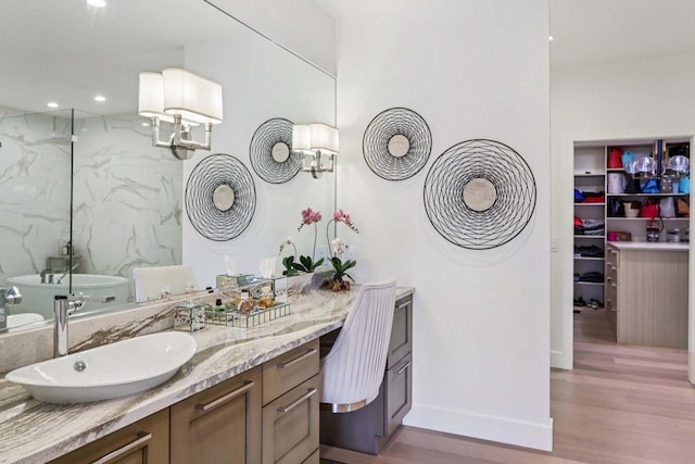 7678 Badger Run Ct, Verona, WI 53593 - full bathroom featuring wood finished floors, vanity, a marble finish shower, baseboards, and a soaking tub